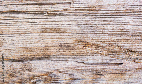 Wood texture background. Top view of a vintage wooden table with cracks. Light brown surface of old wood with knots in natural color