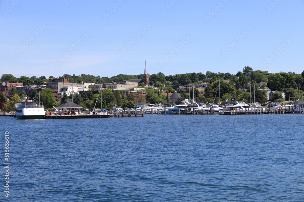 The beautiful skyline of downtown Petoskey, Michigan with the marina and harbor in the summer.