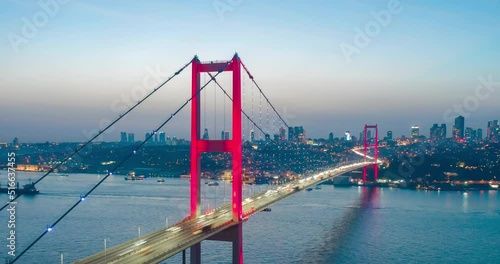 Aerial view of Istanbul Bosphorus Bridge at Sunset with transport traffic lights and City Skyline, vessels and boats sailing, Hyperlapse at evening Motion drone Time Lapse, shipping channel