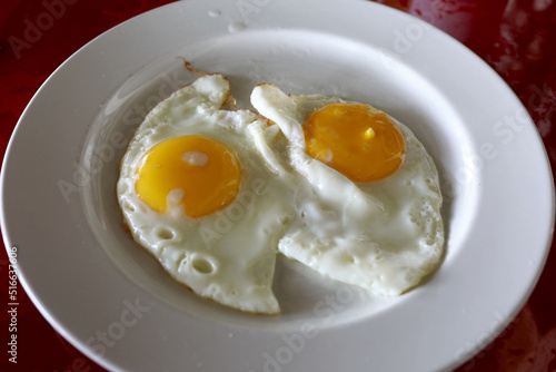 White plate with fried eggs photo