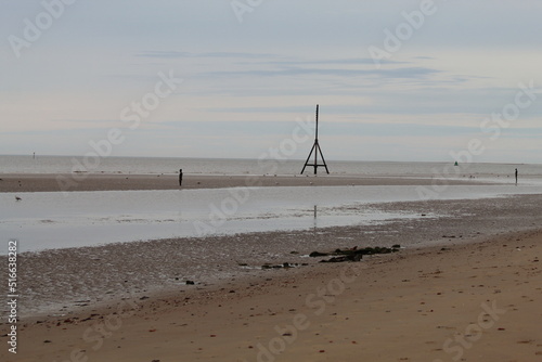 A beautiful landscape shot taken at Crosby Beach in Merseyside. This image was taken on a summer but overcast day. This beach is famous for its Iron Men