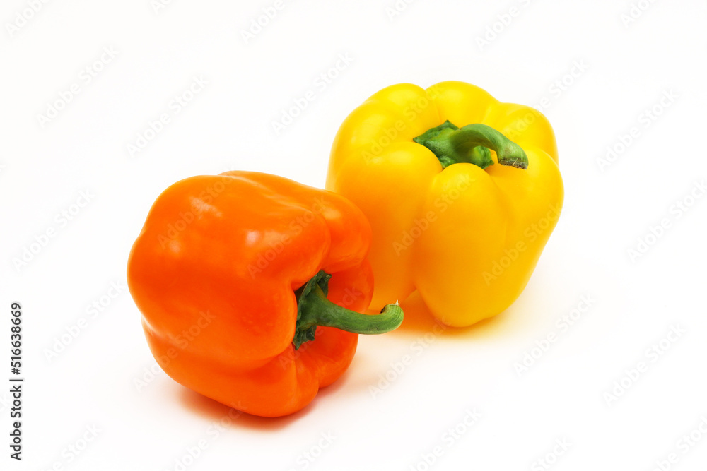 Orange and yellow peppers on a white background. Shallow depth of field Orange and yellow peppers on a white background. Shallow depth of field