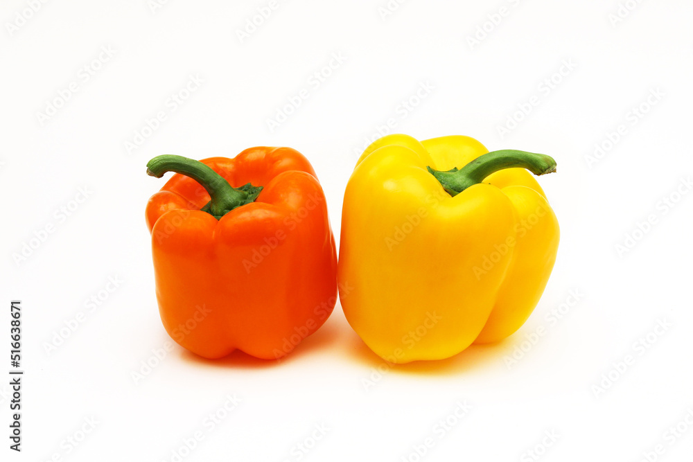 Orange and yellow peppers on a white background. Shallow depth of field Orange and yellow peppers on a white background. Shallow depth of field