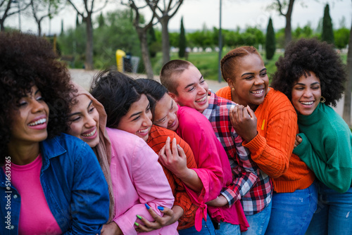Group of young women of different ethnicities together giving each other a hug
