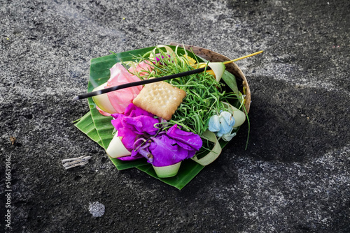 Beautiful balinese offering with a stick of incense