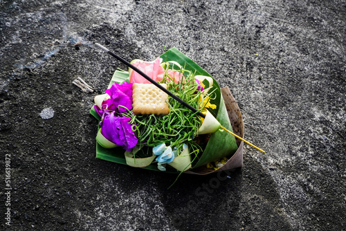 Beautiful balinese offering with a stick of incense