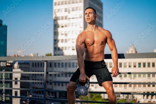Young fit man exercising in a gym