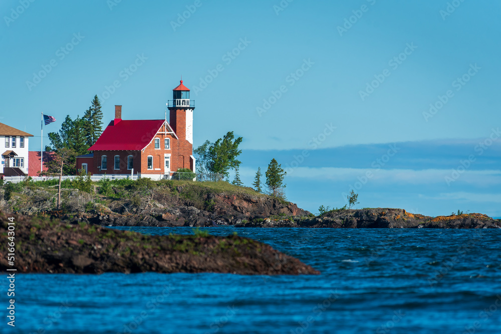 Eagle Harbor Lighthouse stands above a rocky entrance to Eagle Harbor