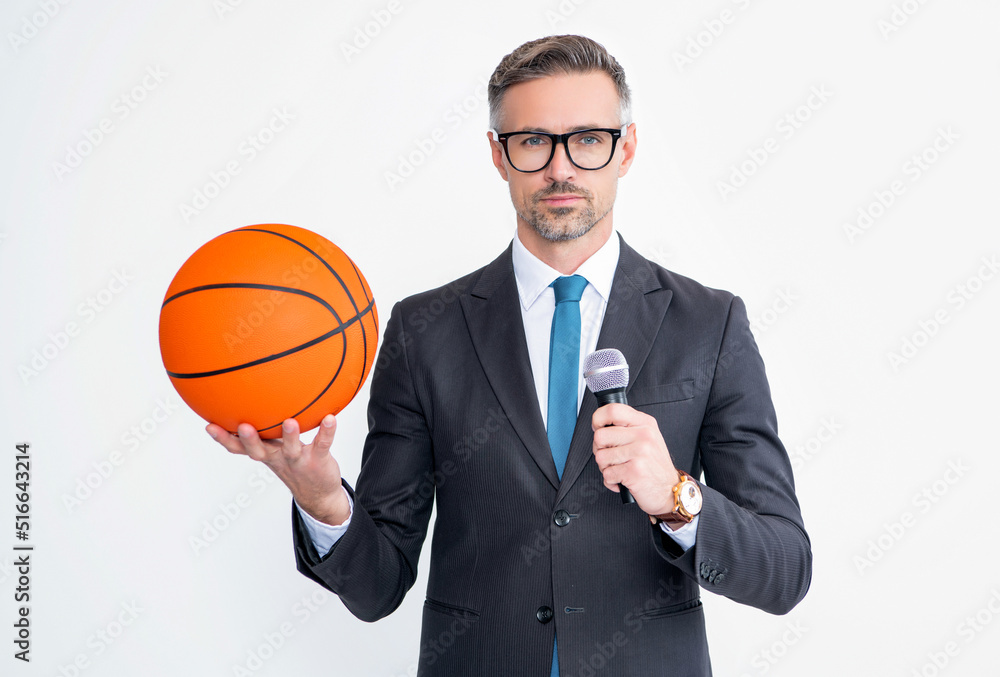 mature man in suit hold basketball ball and microphone isolated on white background
