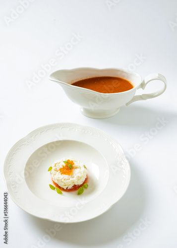 gazpacho with tomato dressing in a plate on a white background