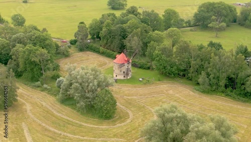 Aerial view of traditional windmill Svetlik in the middle of fields near pond. North of the Czech Republic photo