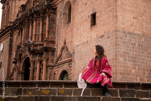Tourist woman looking at cusco cathedral in plaza mayor, Peru photo