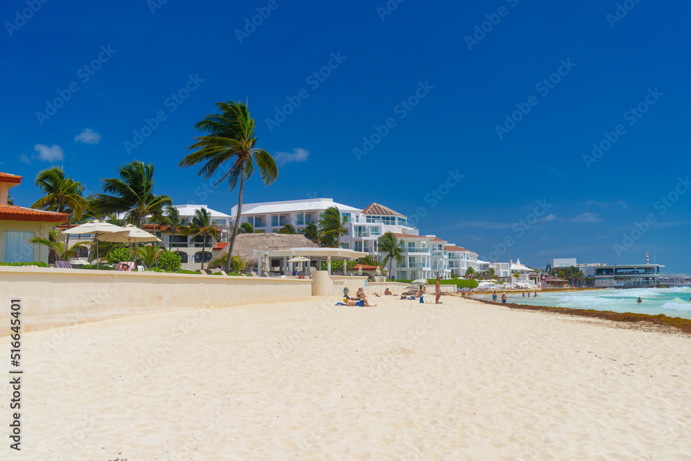 Sandy beach on a sunny day with hotels in Playa del Carmen, Mexico