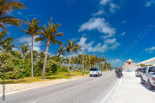 SUV driving on the road with palms on a sunny day near Cancun, Mexico