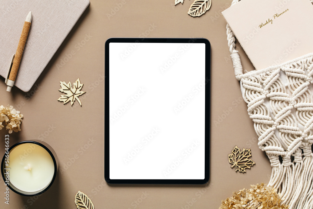 Stockfoto med beskrivningen Tablet pad with blank screen mockup on  aesthetic feminine workspace. Elegant home office desk table with tablet,  macrame bag, paper notebooks, candle, decorations. | Adobe Stock