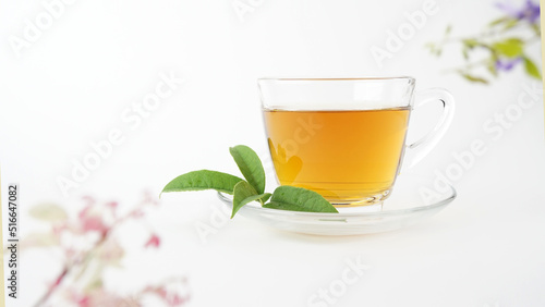  Cup of tea with green leaf isolated on white background.Clear glass.