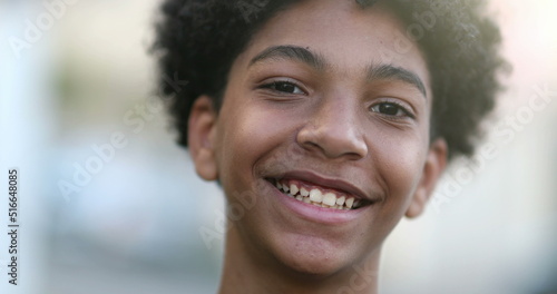 Child boy smiling to camera portrait  mixed race kid  ethnically diverse boy smile outside