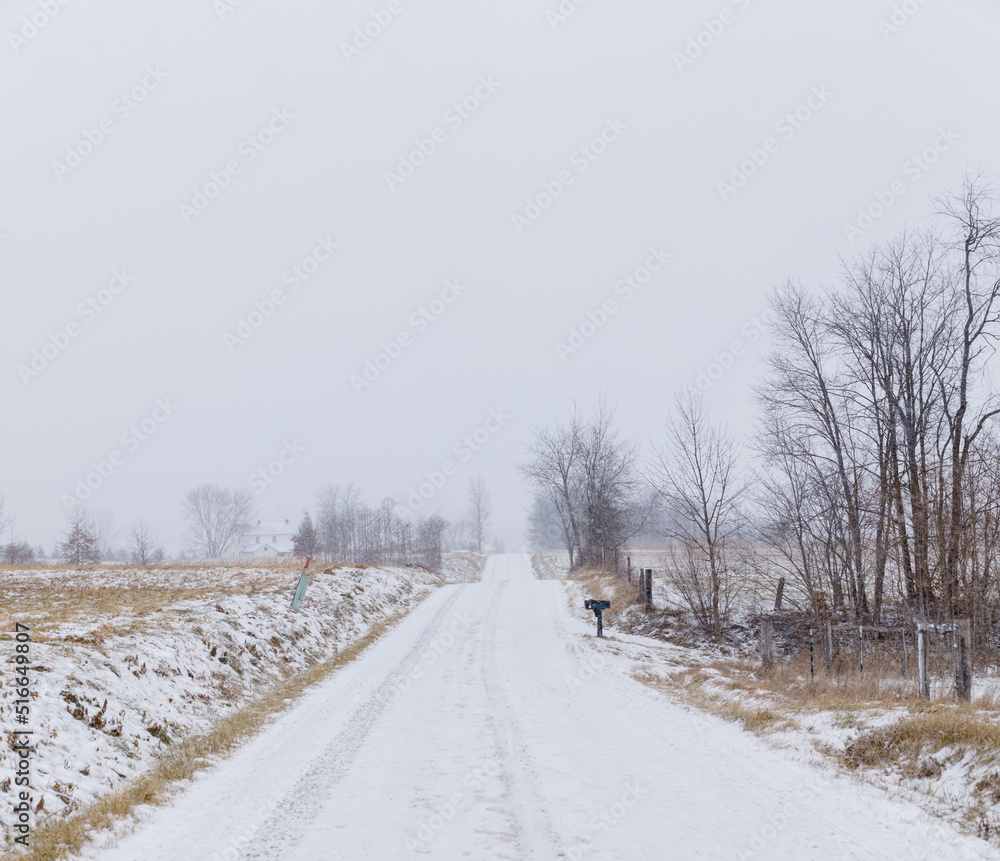 Straight snowy road through the Amish countryside in Holmes County, Ohio