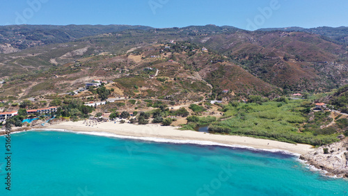 Aerial drone photo of famous bay and organised sandy beach of Livadi Armenistis, popular for surfing sports, Ikaria island, Northeast Aegean, Greece © aerial-drone