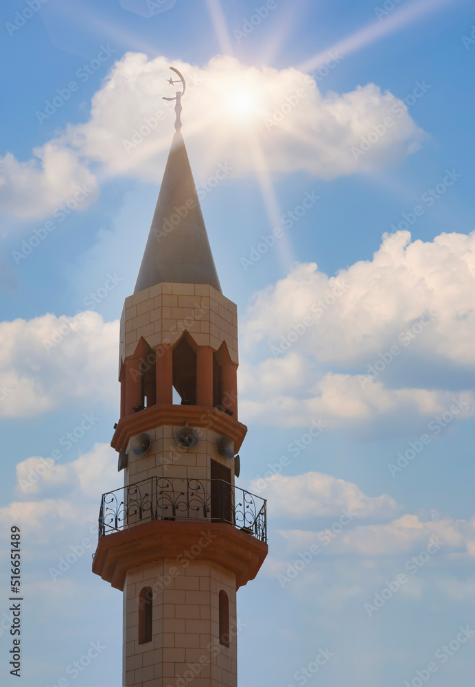 Ordinary modern mosque of muslim of city Tamra in Israel. Crescent on dome and minaret of mosque against blue sky. Symbol of Islam and Ramadan. Tourism, travel concept, islamic background. Copy space Ordinary modern mosque of muslim of city Tamra in Israel. Crescent on dome and minaret of mosque against blue sky. Symbol of Islam and Ramadan. Tourism, travel concept, islamic background. Copy space