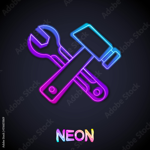 Glowing neon line Crossed hammer and wrench spanner icon isolated on black background. Hardware tools. Vector