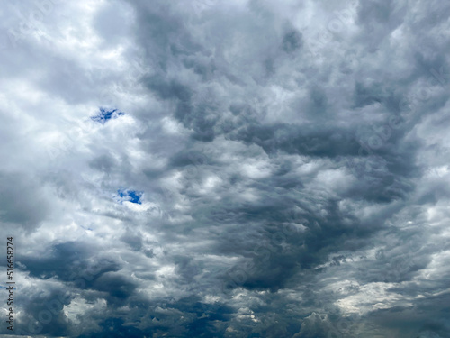 Thick gray clouds with a clear blue sky