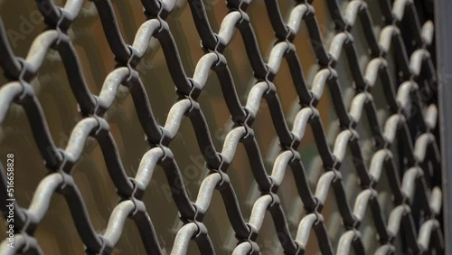 Shutter in the shop window. Iron grating sloping down on the shop window. Safety grating.