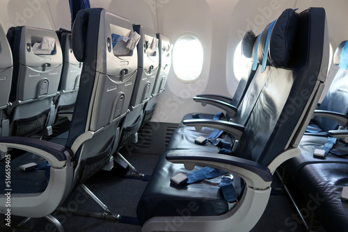 Passenger plane interior details. Empty seats with safety belts. A moment before passengers board 
