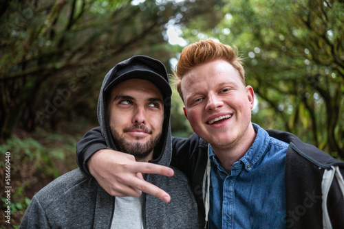 фотографія Two caucasian happy male friends enjoying nature and posing for the camera