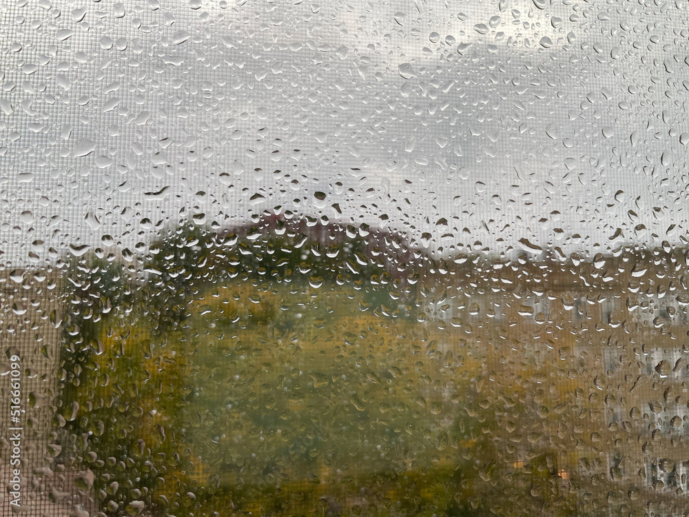 Closeup - heavy rain drops on the window and screen during hurricane Closeup - heavy rain drops on the window and screen during hurricane