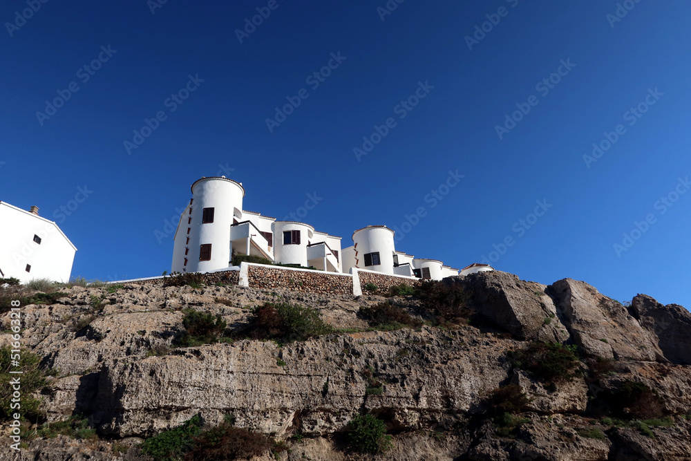 Summer apartments on the cliff near the Platja de Cales Piques, Menorca (Minorca), Spain