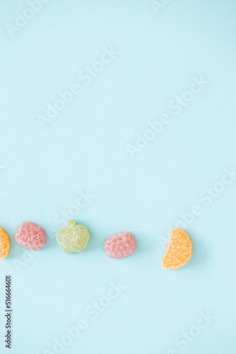 jelly color fruit sweets on blue background