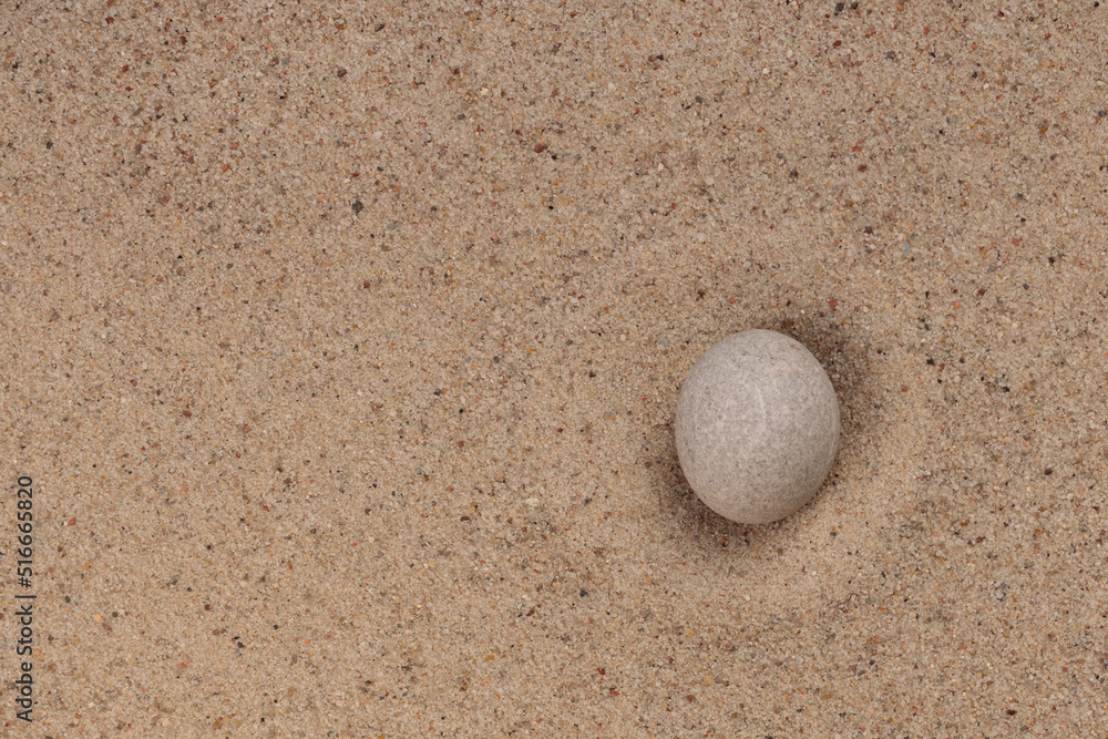 White stone on sand for relaxation balance and harmony spirituality or wellness spa. Top view. White stone on sand for relaxation balance and harmony spirituality or wellness spa. Top view.