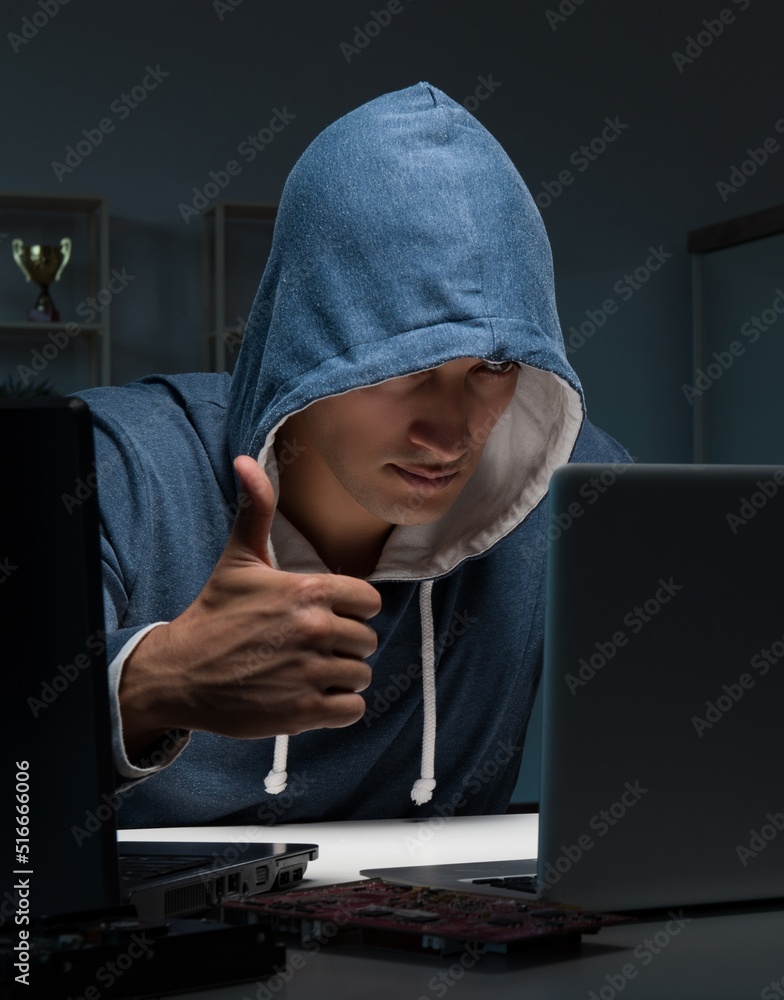 Hacker hacking computer at night