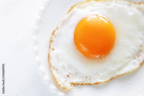 Homemade comfort food, sunny side up fried egg on white plate © jreika