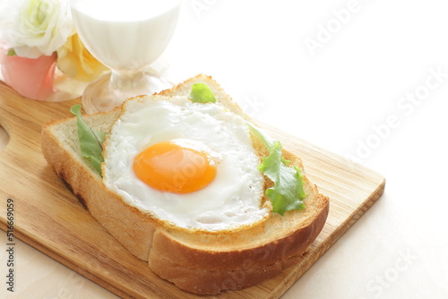 Sunny side up fried egg on toast with glass of milk  for nutritional breakfast 