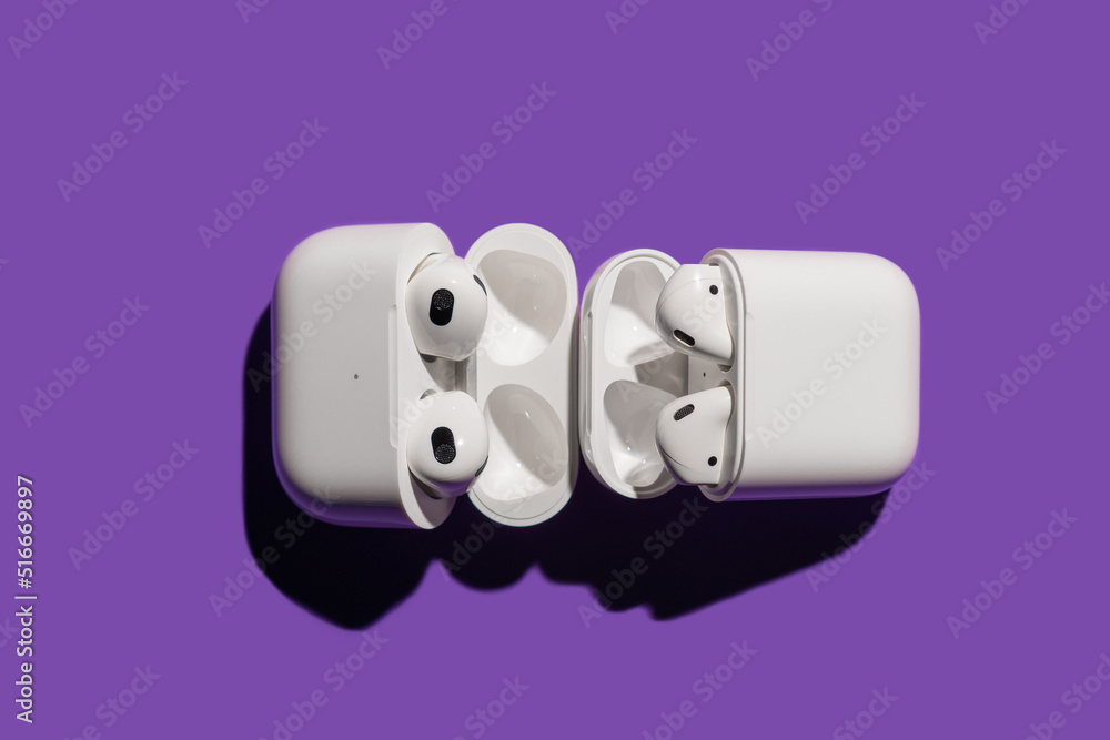 Barcelona, Spain - July 2022. Airpods pro compared with apple air pods 2 in  wireless charging case on violet background. Headphones, vertical, copy  space. Music, technology, electronics concept Stock Photo | Adobe Stock