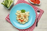 Tasty pasta served with vegetables on wooden table, flat lay. Creative idea for kid lunch
