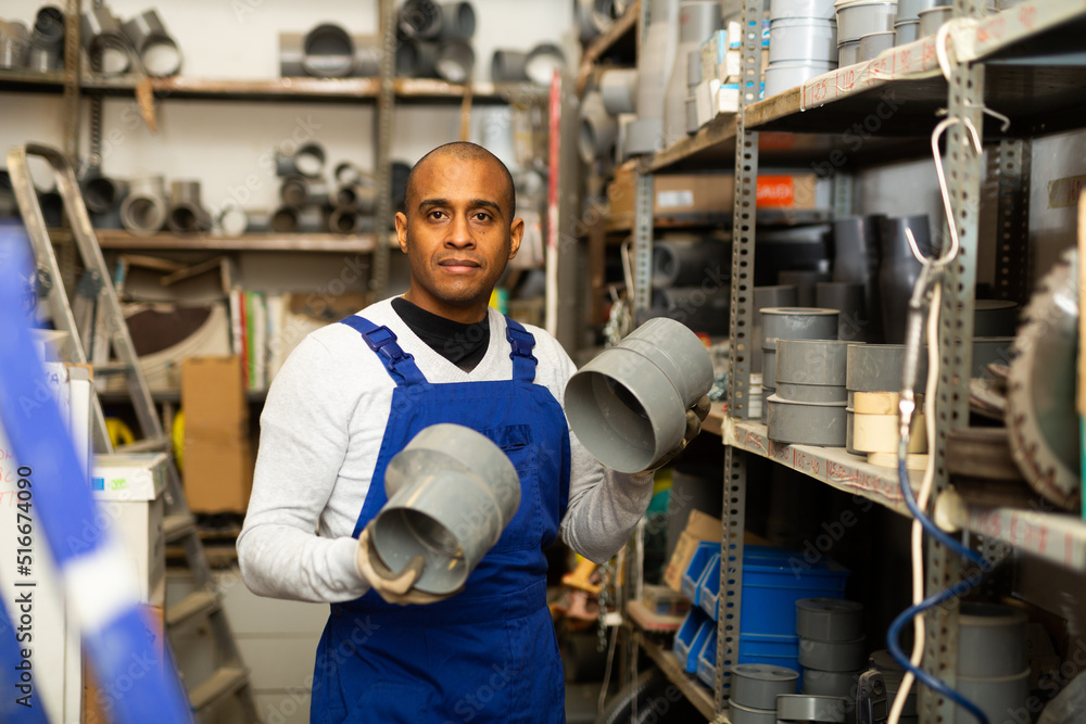 Confident latin american handyman man choosing materials for overhauls in building materials store
