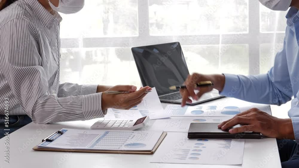 Business people checking details and writing on paper that shows chat of accounting statistics on the table. Business people checking details and writing on paper that shows chat of accounting statistics on the table.