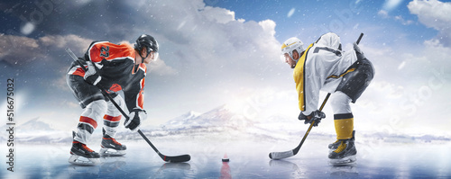Hockey concept. Two professional hockey players start the game in ice. Fight for the puck. Sports emotions. Winter