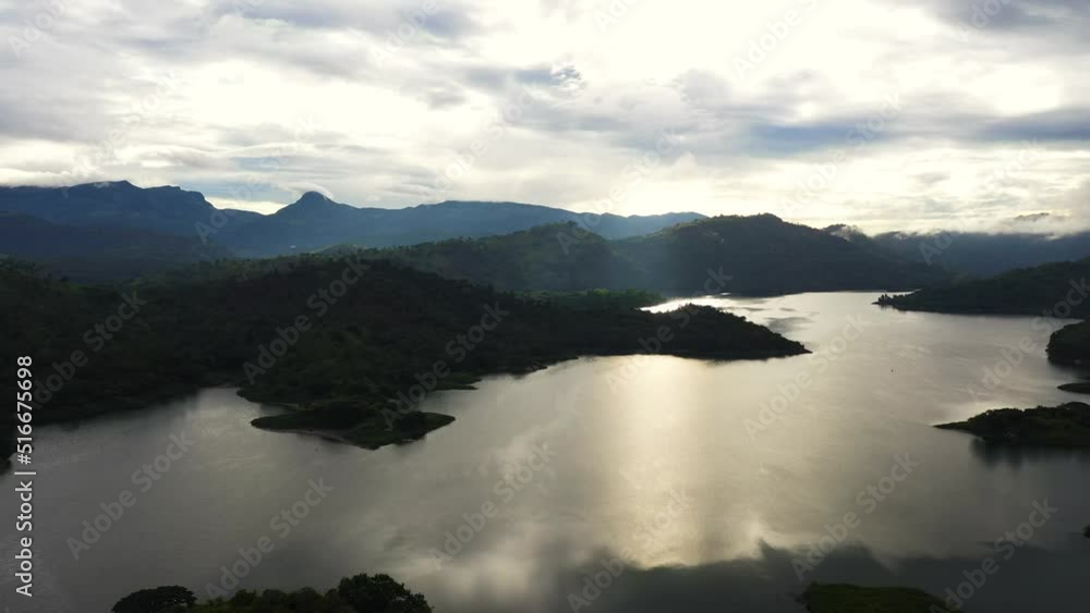Top view of lake among green hills and mountains early in the morning. Tropical landscape. Victoria Reservoir, Sri Lanka. Top view of lake among green hills and mountains early in the morning. Tropical landscape. Victoria Reservoir, Sri Lanka.