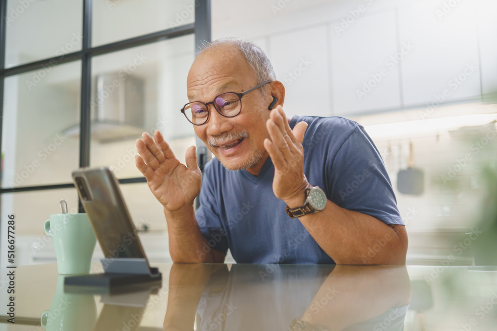 Cheerful Middle aged man making video call on smartphone with his family, Chinese Senior man having fun with mobile phone at home, Leisure, Active Lifestyle