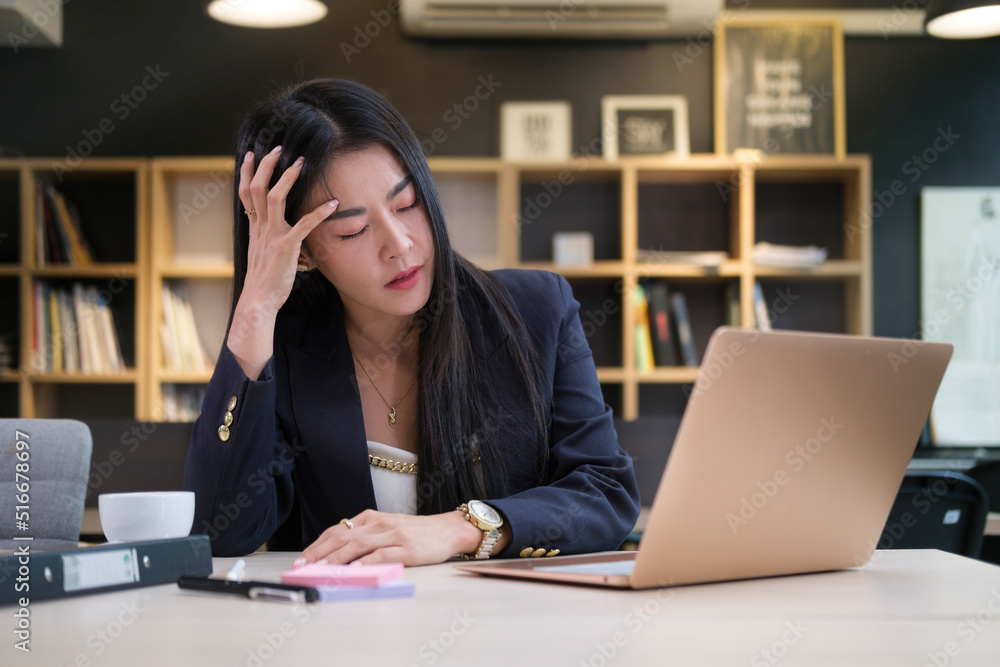 Exhausted asian female entrepreneur suffering from headache touching temples, stress at work or migraine. Exhausted asian female entrepreneur suffering from headache touching temples, stress at work or migraine.