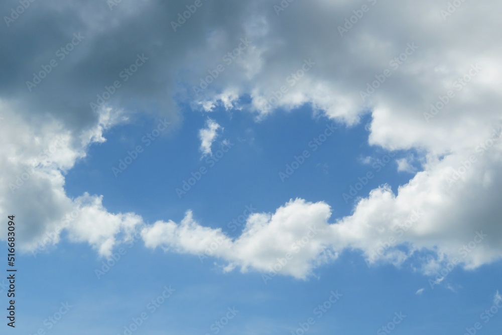 Beautiful blue sky surrounded by white fluffy clouds Beautiful blue sky surrounded by white fluffy clouds