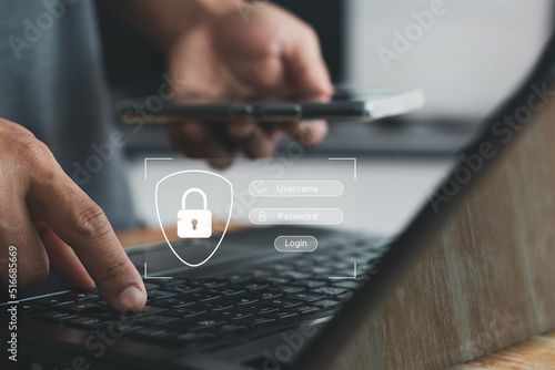 Concept of cyber security, information security and encryption. Man hand typing on a keyboard with login and password on-screen display. login, password, data protection and secured internet access.