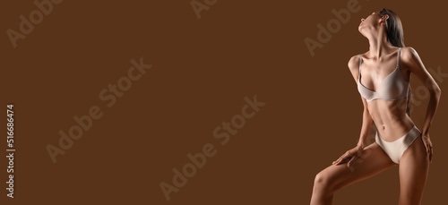 Photos Young skinny woman in underwear on brown background with space for text