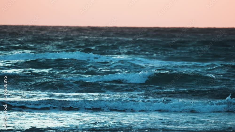 Mesmerizing sunset over the stormy sea. Slow-motion, pan left. Mesmerizing sunset over the stormy sea. Slow-motion, pan left.