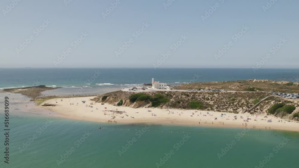 Aerial view around the lighthouse in Vila Nova de Milfontes, sunny Portugal - orbit, drone shot Aerial view around the lighthouse in Vila Nova de Milfontes, sunny Portugal - orbit, drone shot