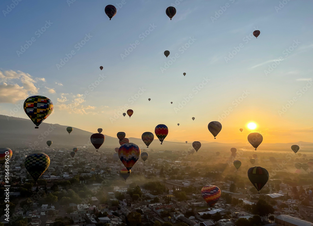 Naklejka premium Colorful Hot Air Balloons Flying Over Ancient Pyramid of Teotihuacan, Mexico at sunrise -sunset, over the mist
